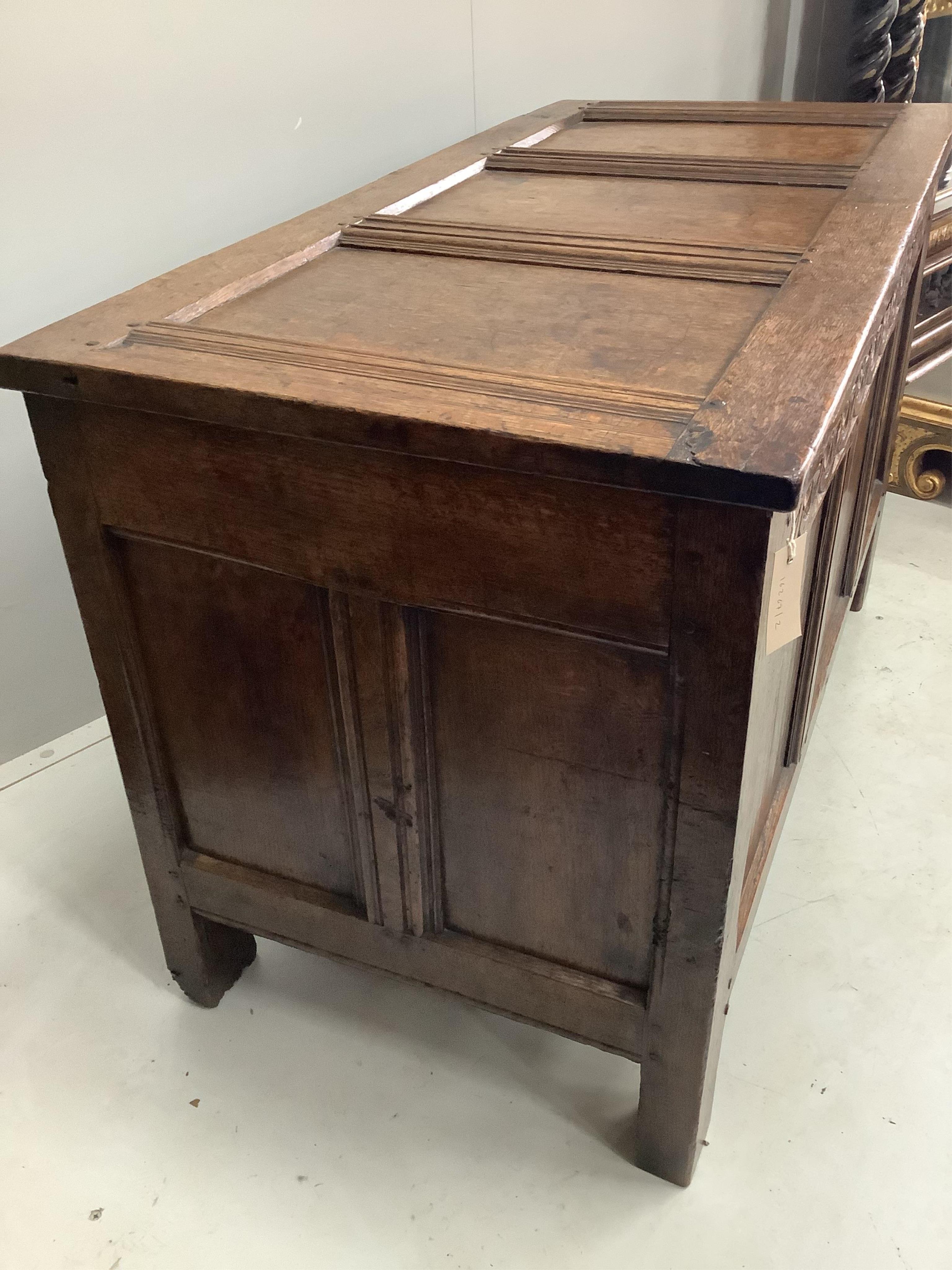 A 17th century oak coffer, width 112cm, height 68cm. Condition - fair to good